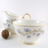 <p>Duchess Tranquillity china has a lovely traditional floral design which looks like blue Forget-me-Nots with shades of pink buds and&nbsp;green foliage.</p>
<p>It has a&nbsp;gold band around the edge on pure white fine English bone china. Just the thing to serve afternoon tea with cakes.</p>
<p>Fine Bone China made in England.</p>
<p>It has a classic Victorian style scalloped edge and a subtle embossed feel to suit elegant and fine dining as well as everyday use.</p>
<p>Every item is simply designed but beautifully and carefully crafted, with one standout feature &ndash; a mesmerising translucent characteristic, due to the exemplary quality of the china.</p>
<p>This unique characteristic &ndash; created by the collection&rsquo;s lead-free reflective glaze &ndash; actually enhances the appearance of all food presentation, therefore helping to make all dining occasions that little bit more special.</p>
<p>Duchess English fine bone china represents excellent value for an English made bone china set.<br /><br /><strong>Official UK Stockist</strong></p>
